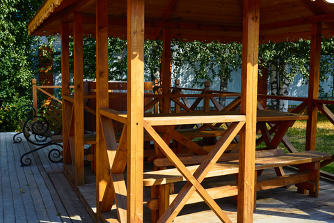 Wooden decking boards in a sunny outdoor setting.